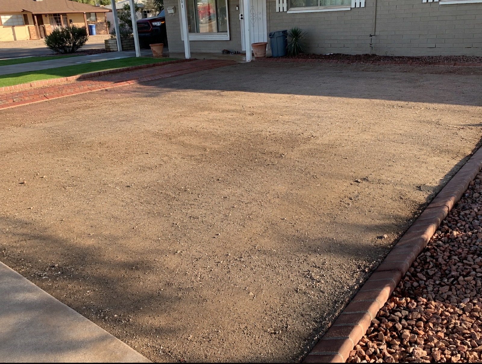 Before: bare prepped front yard ready for sod