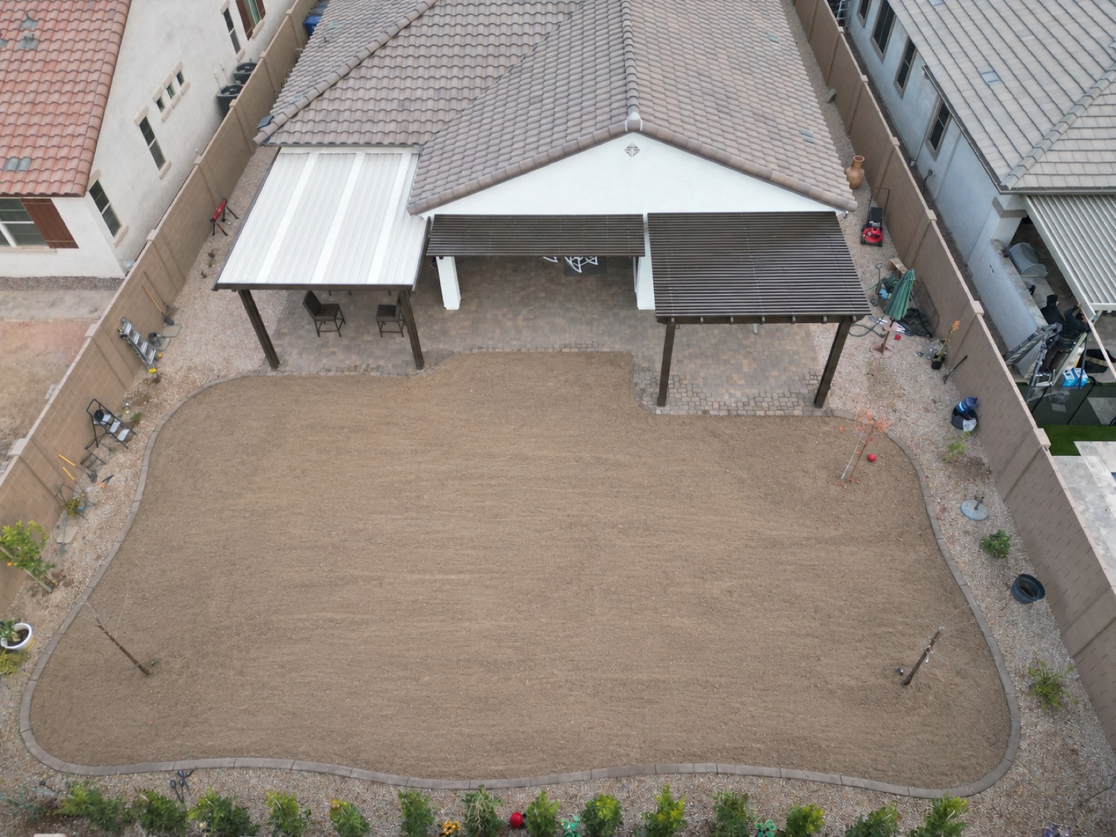 Before: backyard between pergolas, bare graded dirt